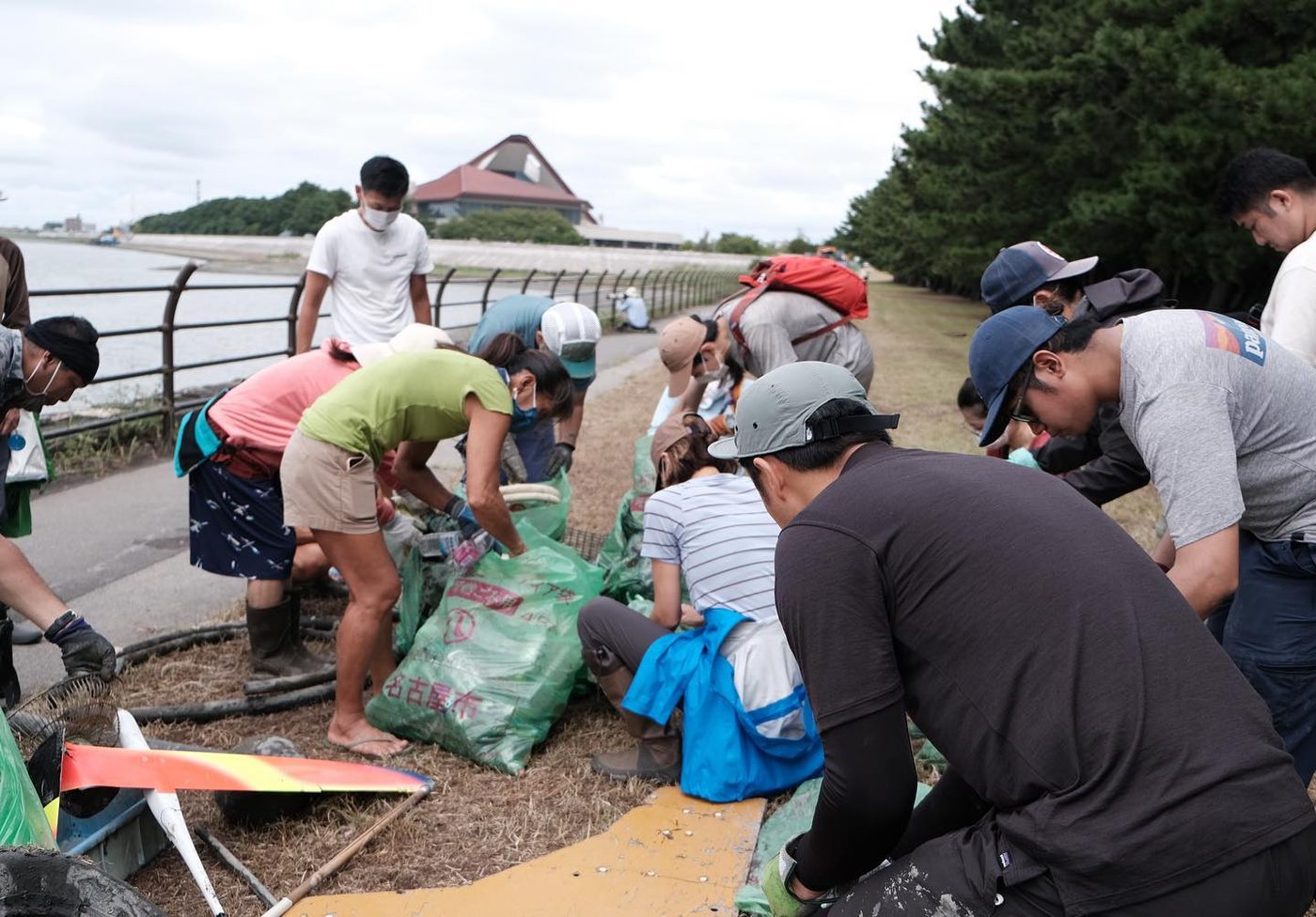Clean-up volunteers working beside the bags of litter they collected