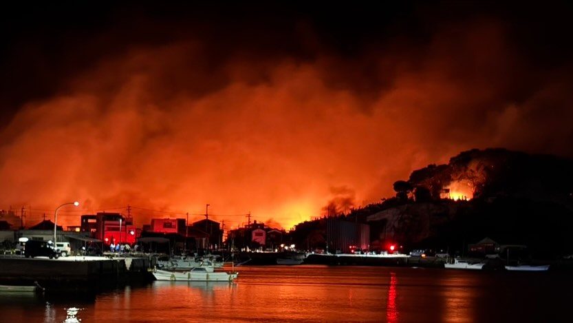 Fire spreading beyond the harbor at night