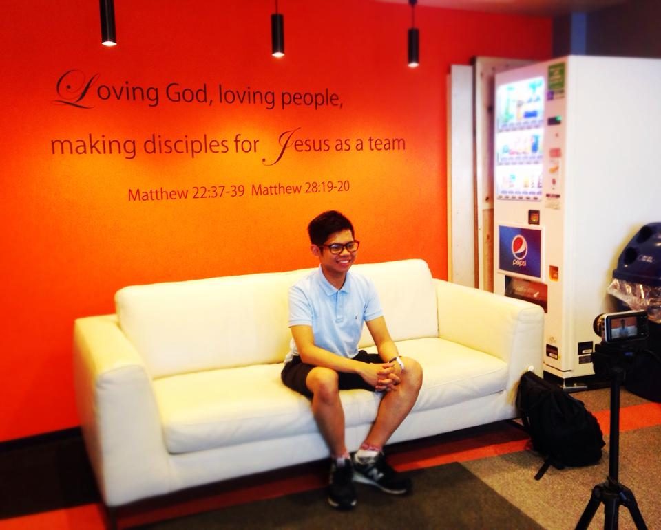 A young Narita Jun sitting on a sofa at church