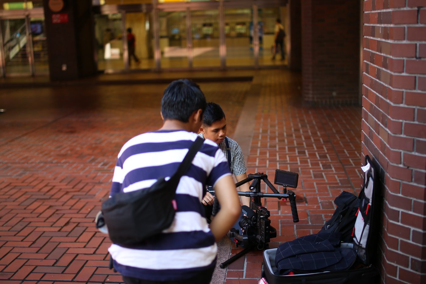 Narita Jun preparing a gimbal camera in the city