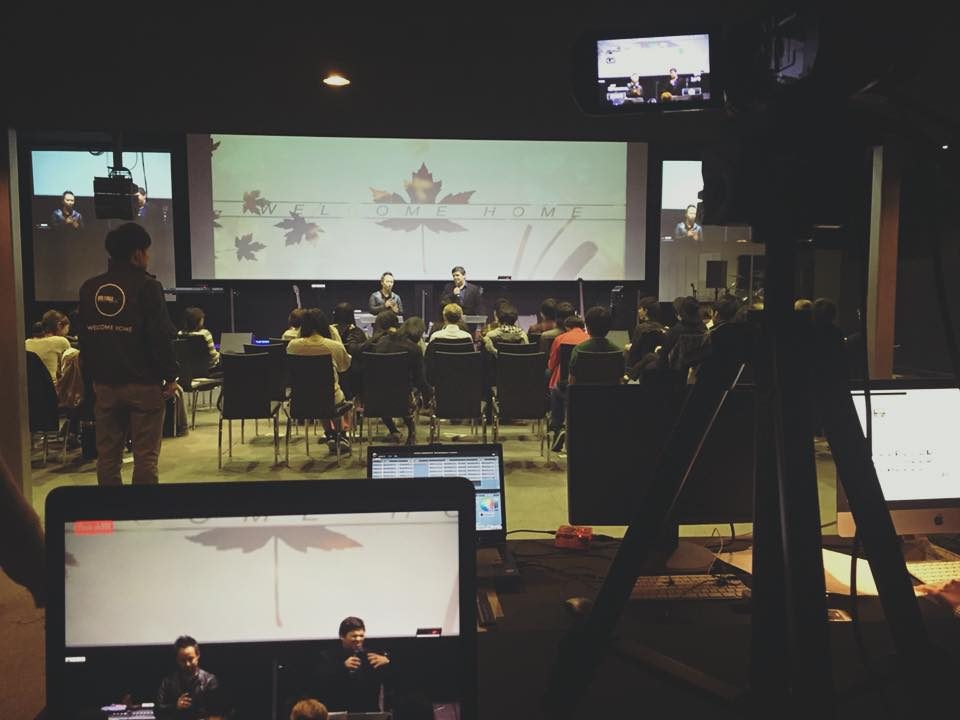 An event venue with projections on a large screen
